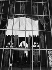 Old Coventry Cathedral reflected in the doors of the new Cathedral